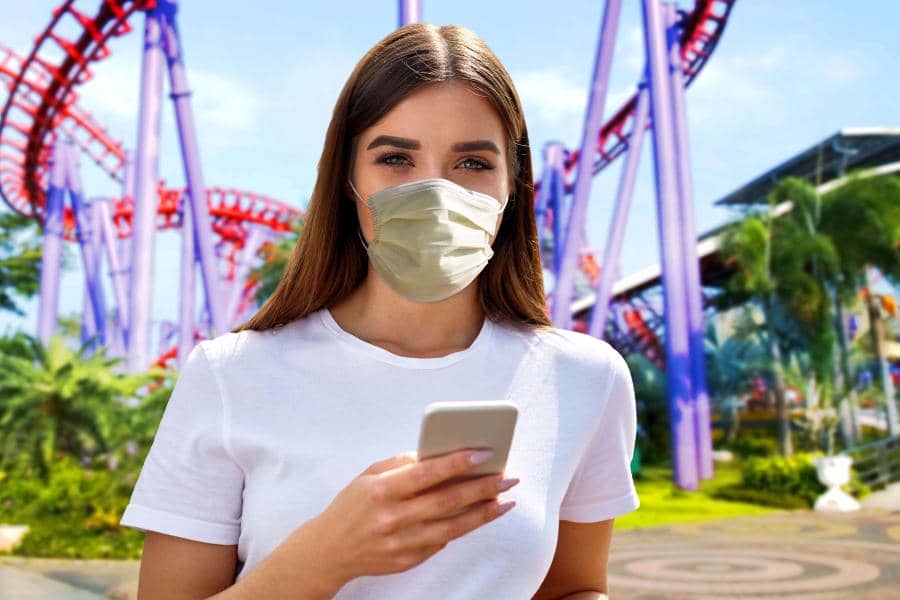 Young girl holding cellphone with mask